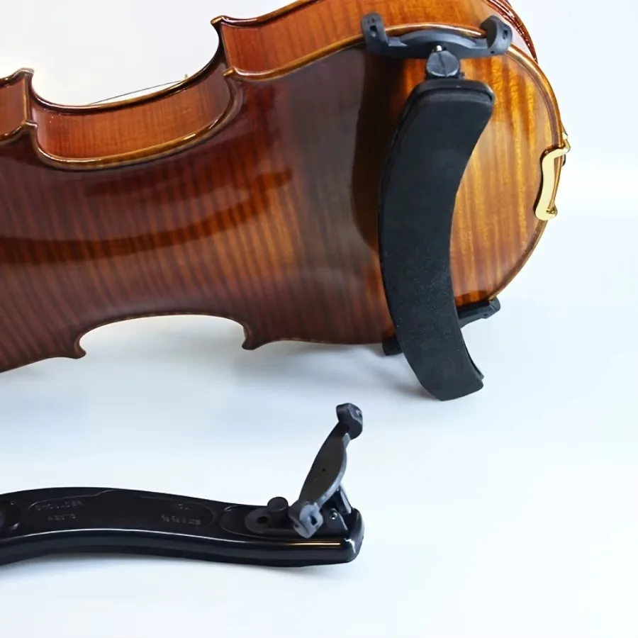 Black foam violin shoulder rest mounted on a flamed maple violin, with a second rest lying flat below showing its collapsible feet folded