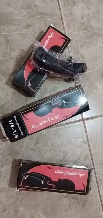 Several Violin Shoulder Rest boxes with one black rest in plastic wrap during unboxing, photographed by Sofia L., a verified buyer