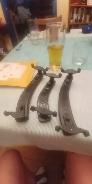 Three all-black shoulder rests on a table with the underside and foldable feet visible, photographed by Rebecca H., a verified buyer